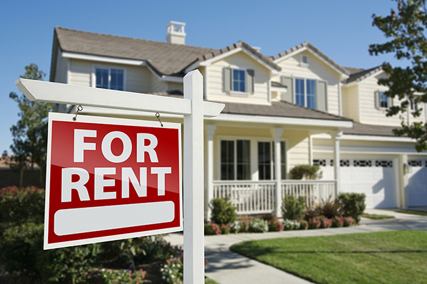 Right Facing Red For Rent Real Estate Sign in Front of Beautiful House